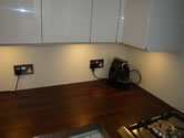 Wooden worktop with white high gloss kitchen
